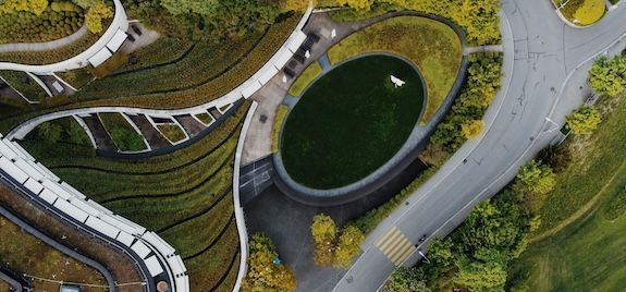 Aerial view of planted roofs and pathways in an urban landscape.