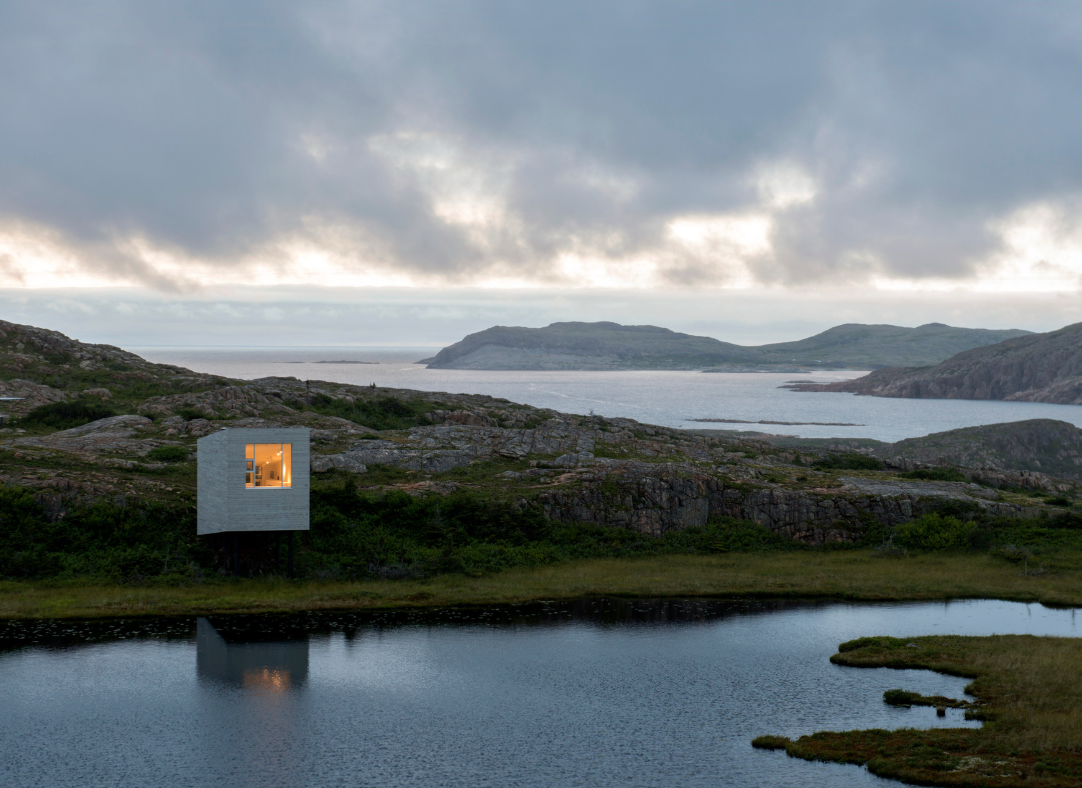 A small research studio overlooking the rocky Fogo Island coastline.